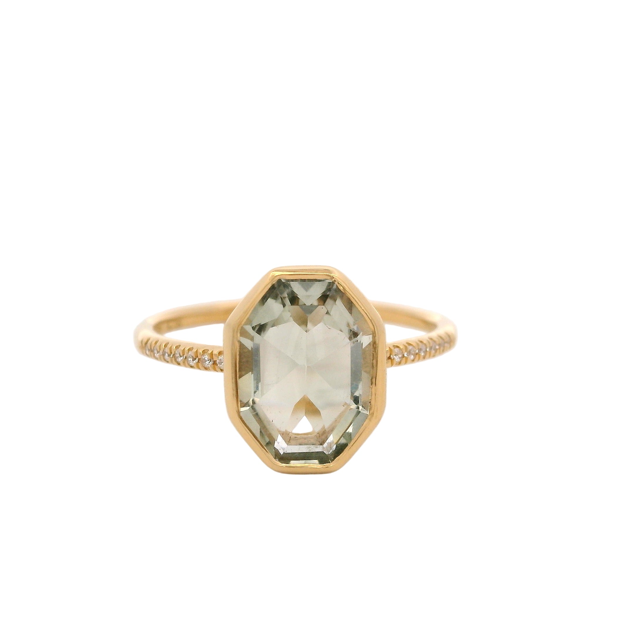 Gold ring with a green gemstone on a white background