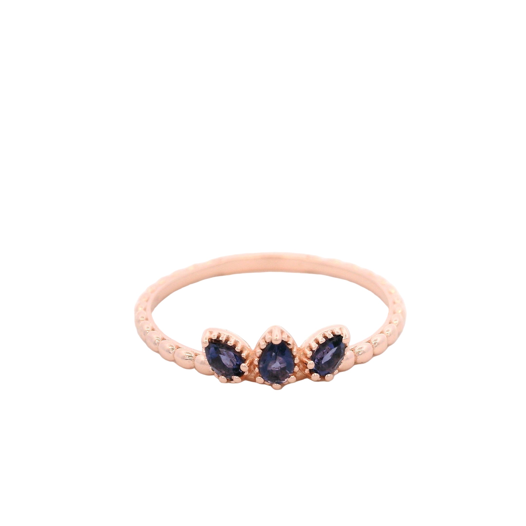 Rose gold ring with three blue gemstones on a white background