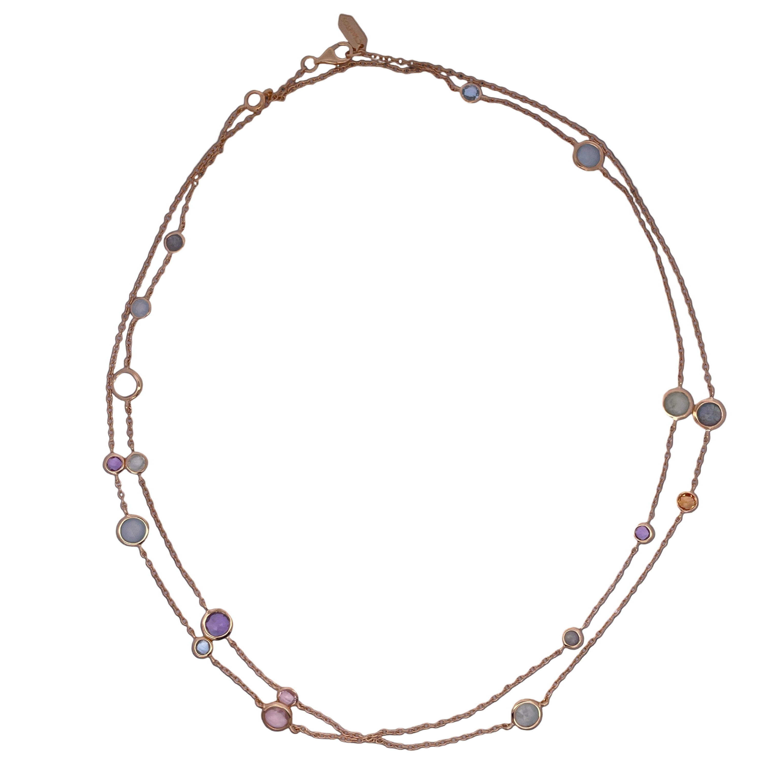 Gold necklace with colorful stones on a white background