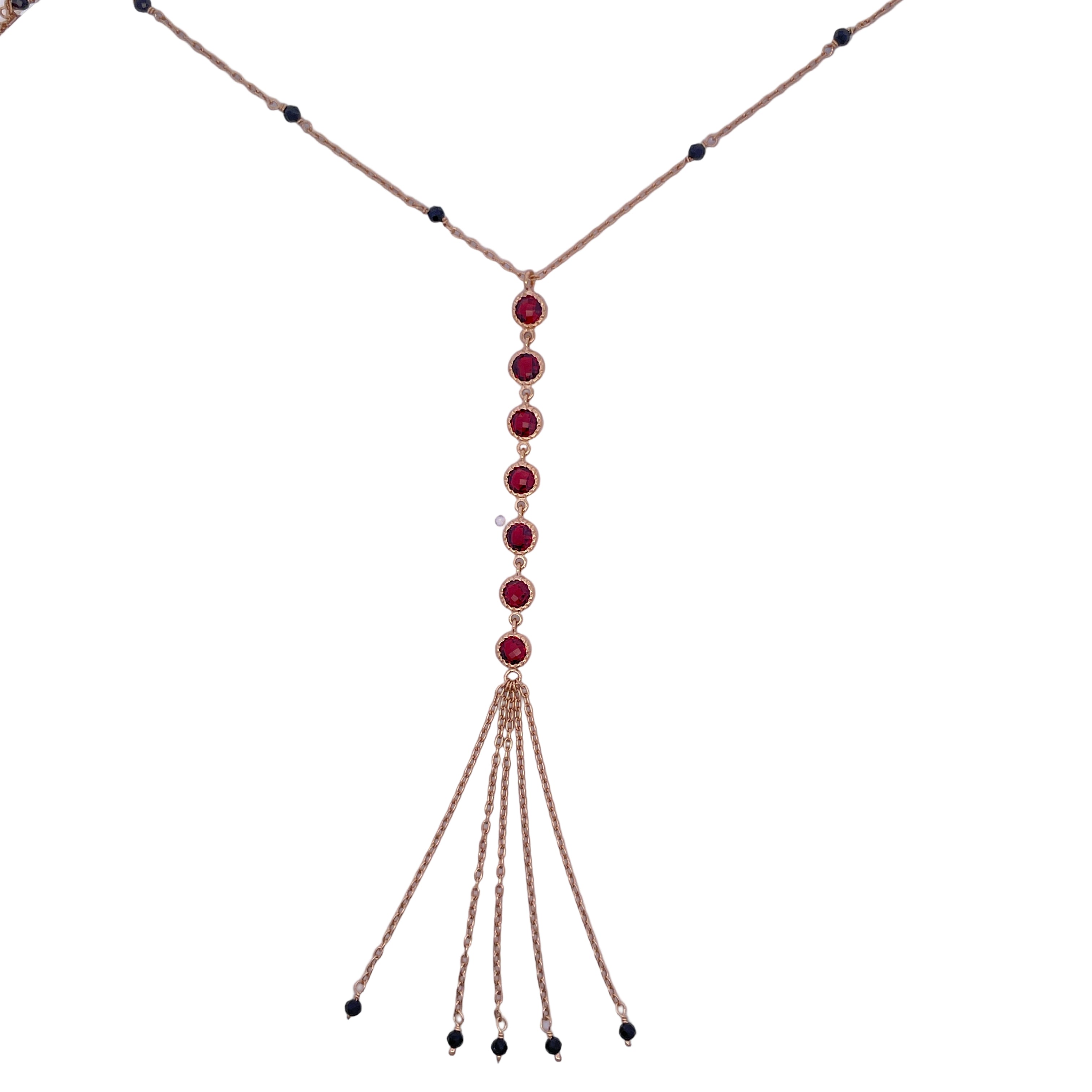 Necklace with red gemstones and gold chains on a white background